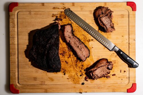 Gerookte brisket in plakken gesneden op een houten snijplank